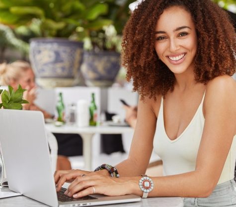 pretty-african-american-female-model-keyboards-something-laptop-computer-connected-free-wireless-internet-cafe-writes-new-article-her-blog_273609-3192
